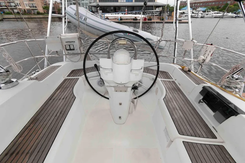 Slide: The Image of Cockpit of 2003 Beneteau 393 sailboat with steering wheel, docked at marina. - 9
