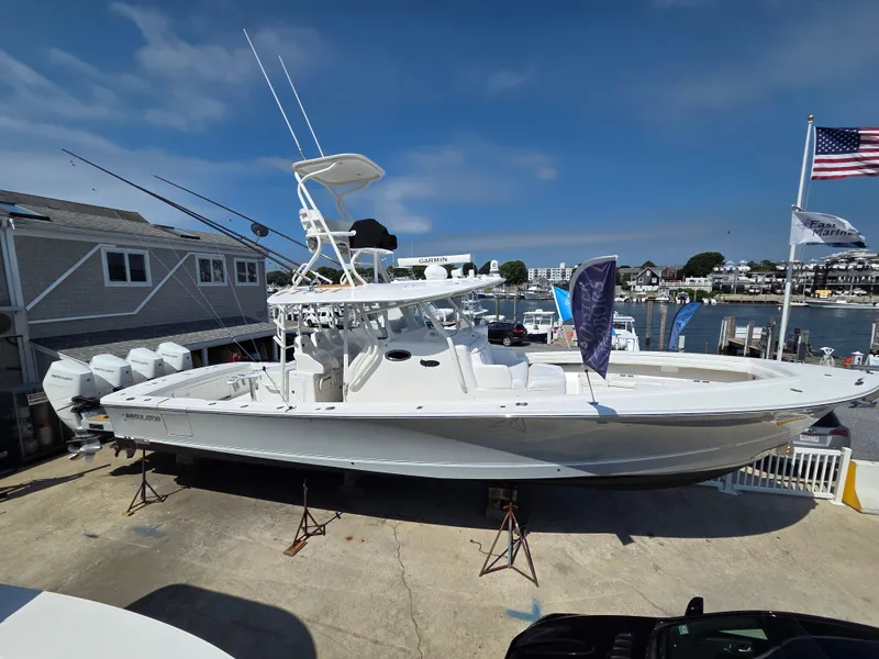 The Image of 2017 Regulator 41 boat cruising in a scenic harbor with waterfront homes. - 0