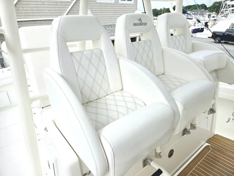 Slide: The Image of Luxurious white seating on a 2017 Regulator 41 boat, featuring diamond stitching and ergonomic design. - 10