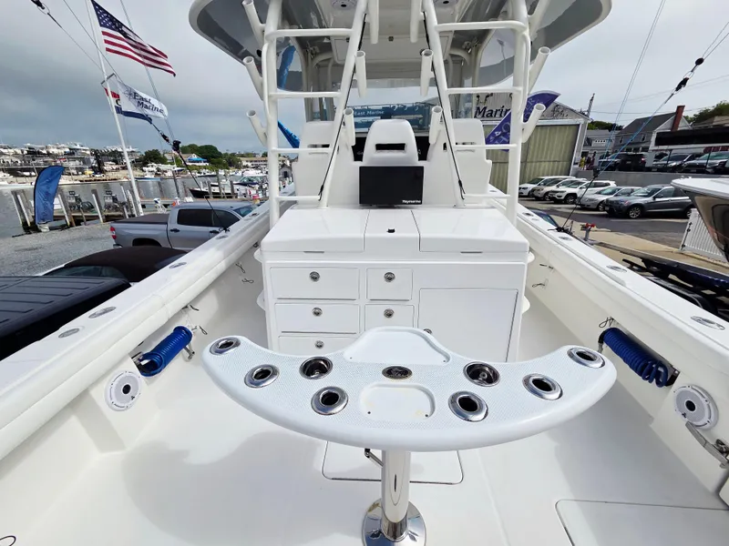Slide: The Image of 2017 Regulator 41 boat interior with fishing rod holders and storage, docked at a marina. - 16