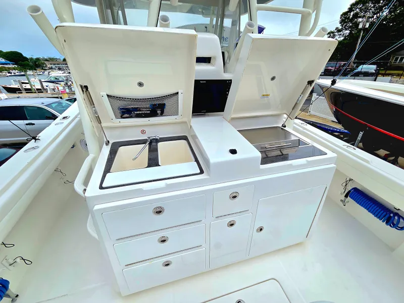 Slide: The Image of 2017 Regulator 41 boat with open storage compartments and sink on deck. - 19
