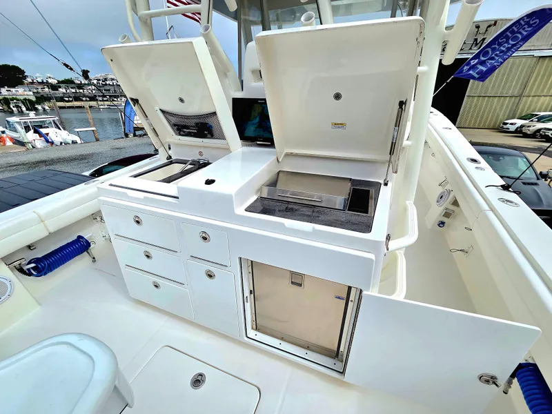 Slide: The Image of 2017 Regulator 41 boat with open storage compartments and built-in grill on deck. - 20