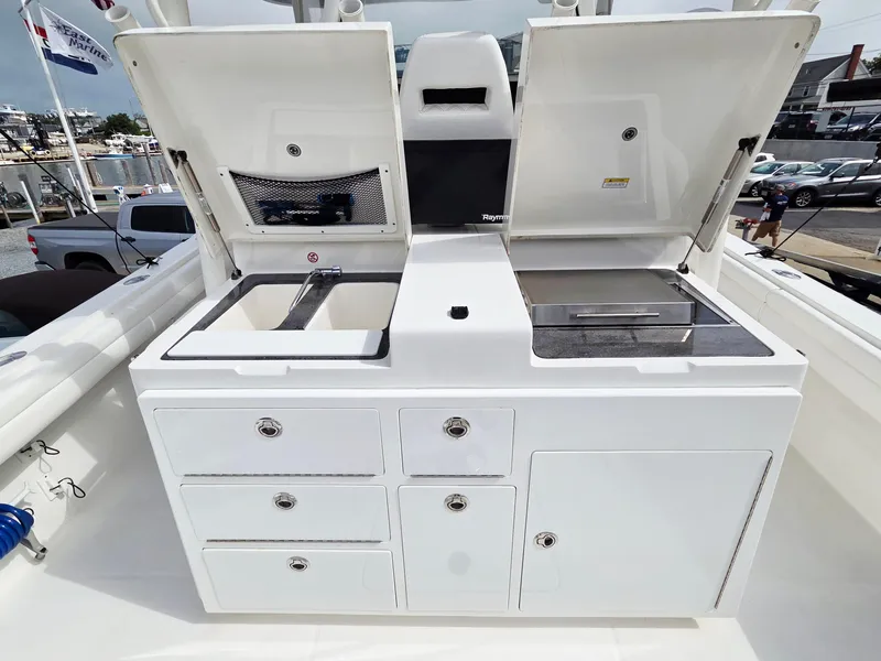 Slide: The Image of 2017 Regulator 41 boat with open storage compartments and sink on deck. - 21