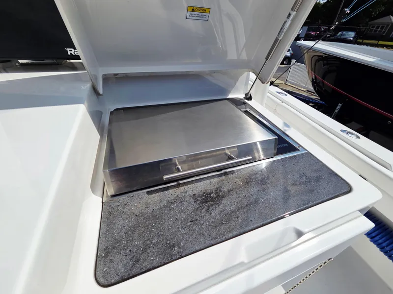 Slide: The Image of Outdoor grill on 2017 Regulator 41 boat, featuring stainless steel cover and countertop. - 23