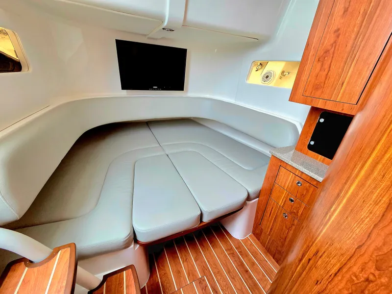Slide: The Image of Luxurious cabin interior of 2017 Regulator 41 boat with wood accents and seating. - 25