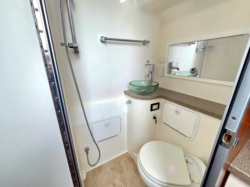 Slide: The Image of Luxurious 2017 Regulator 41 boat bathroom with modern fixtures and glass sink. - 29