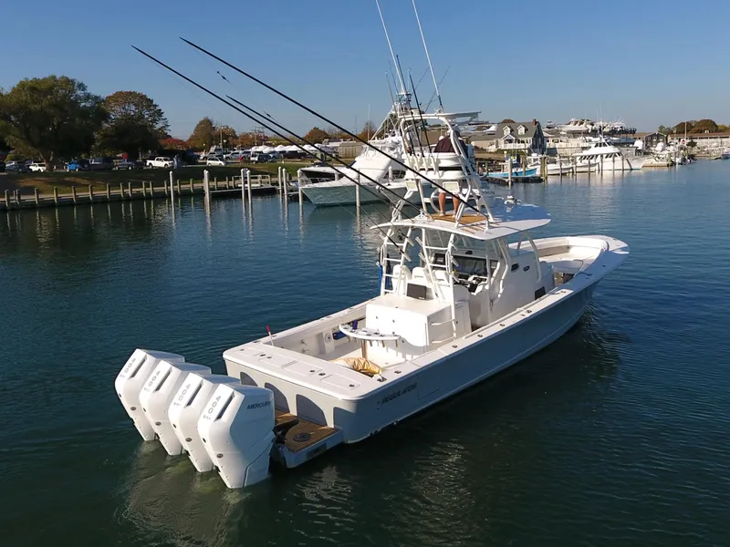 Slide: The Image of 2017 Regulator 41 boat with multiple outboard engines docked in a marina. - 3