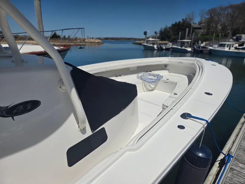Slide: The Image of 2017 Regulator 41 boat docked in a serene marina setting. - 30