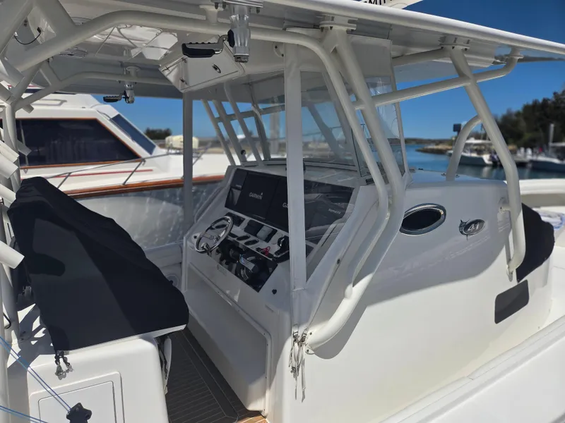 Slide: The Image of 2017 Regulator 41 boat cockpit with modern controls and seating, docked at marina. - 31
