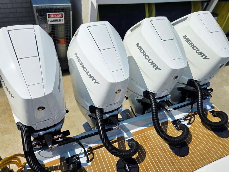 Slide: The Image of Four Mercury outboard engines on a 2017 Regulator 41 boat, docked near a flammable materials sign. - 33