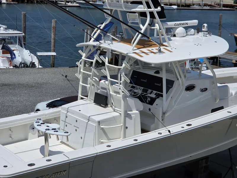 Slide: The Image of 2017 Regulator 41 boat with advanced Garmin navigation, docked at a marina. - 36