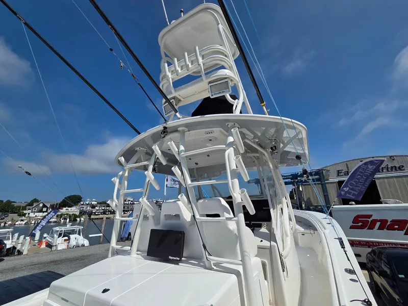 Slide: The Image of 2017 Regulator 41 boat with tower, docked under clear blue sky. - 37