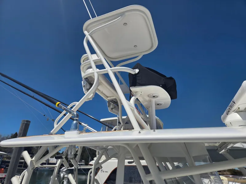 Slide: The Image of 2017 Regulator 41 boat tower with seating and fishing rods under clear blue sky. - 38