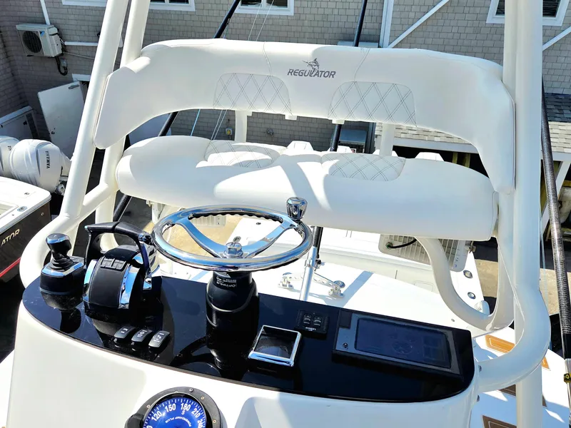 Slide: The Image of Helm of 2017 Regulator 41 boat with steering wheel and controls. - 39