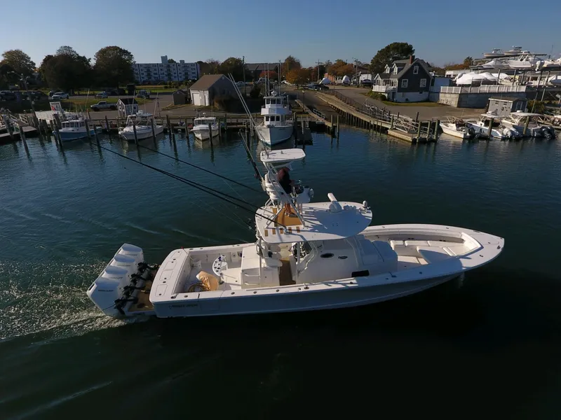 Slide: The Image of 2017 Regulator 41 boat docked in a marina, featuring multiple outboard engines. - 4