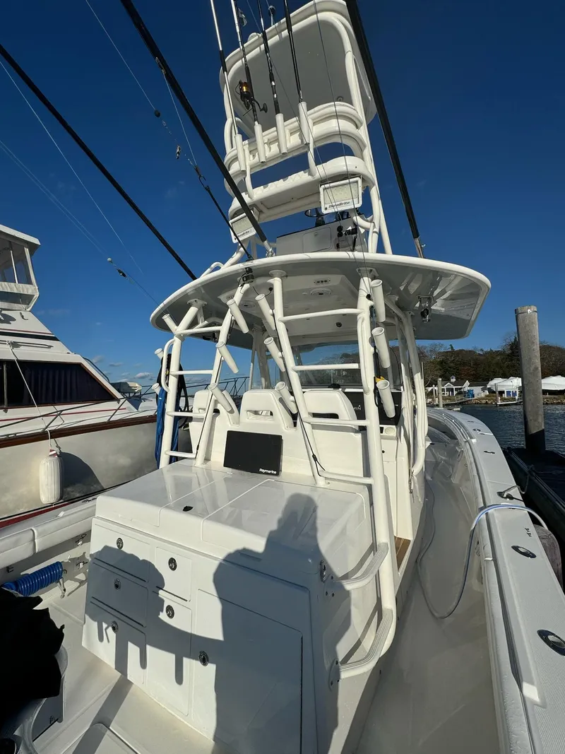 Slide: The Image of 2017 Regulator 41 boat with tower, docked at marina under clear blue sky. - 5