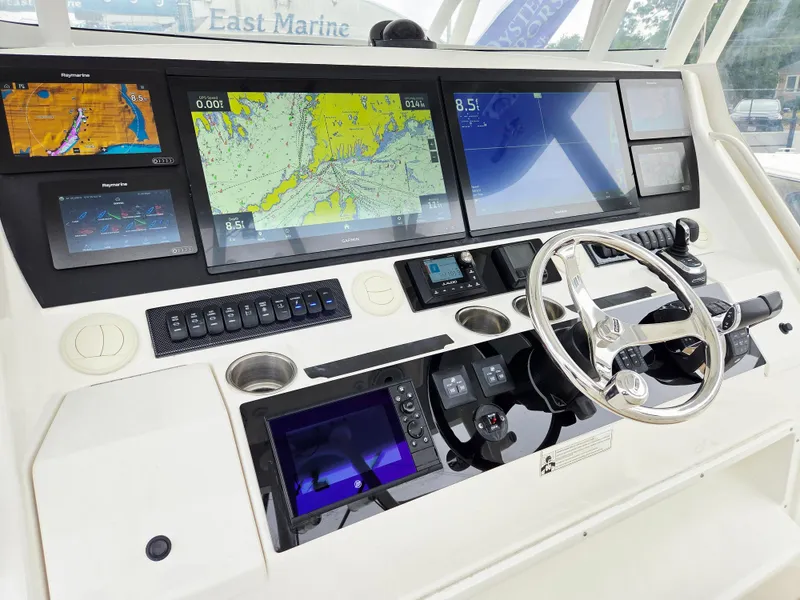 Slide: The Image of 2017 Regulator 41 boat dashboard with advanced navigation displays and controls. - 7