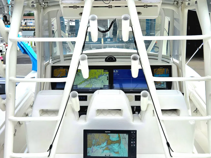 Slide: The Image of Cockpit of 2017 Regulator 41 boat with advanced navigation displays and rod holders. - 9