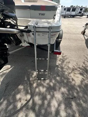 Slide: The Image of 2022 Tracker T16 boat with ladder, parked in a lot. - 14