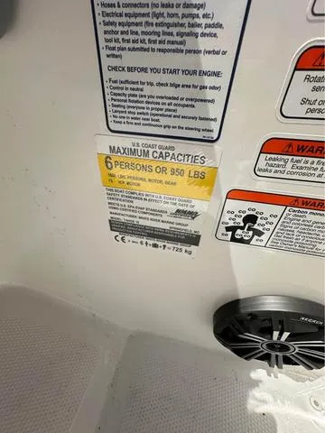 Slide: The Image of Capacity label on 2022 Tracker t16 boat, maximum 6 persons or 950 lbs. - 16