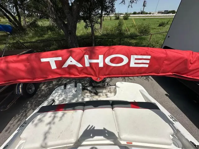 Slide: The Image of Red Tahoe boat cover on a 2022 Tracker T16, parked outdoors. - 5