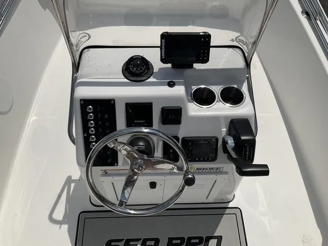 Slide: The Image of 2025 Sea Pro 172 Bay boat console with steering wheel and navigation equipment. - 4