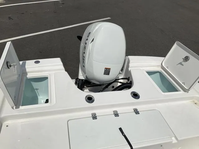 Slide: The Image of 2025 Sea Pro 172 Bay boat with Suzuki outboard motor and open storage compartments. - 6