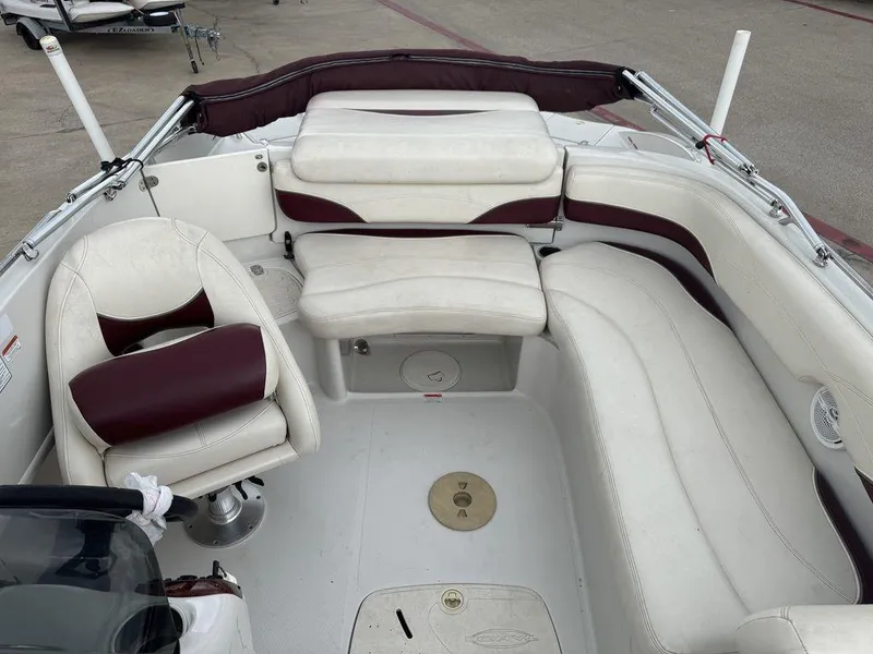 Slide: The Image of Interior of a 2013 Tahoe 195 boat with white and maroon seating. - 7