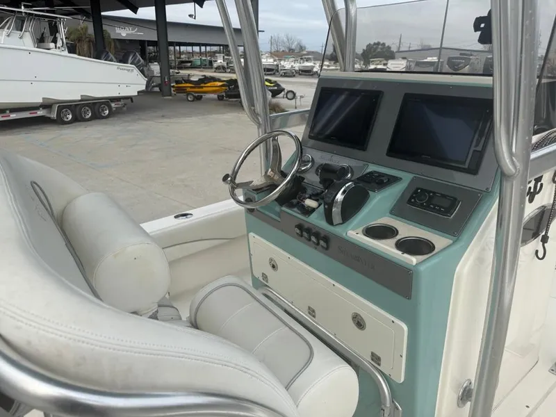 Slide: The Image of 2017 ShearWater 270 Carolina Flare boat console with dual screens and steering wheel. - 10