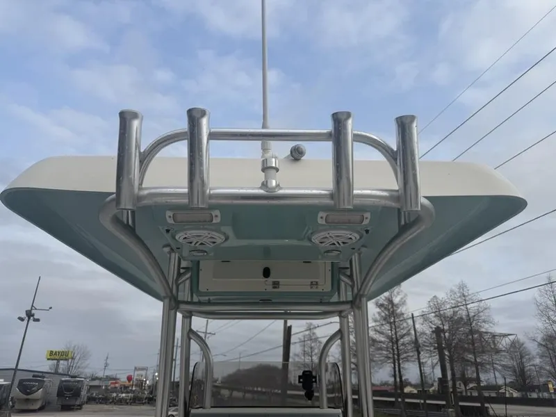 Slide: The Image of 2017 ShearWater 270 Carolina Flare boat with T-top and rod holders, under a cloudy sky. - 12