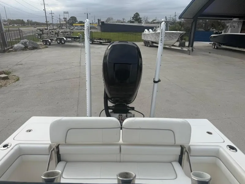 Slide: The Image of 2017 ShearWater 270 Carolina Flare boat with outboard motor in a parking area. - 17
