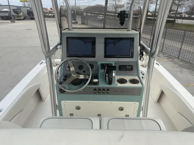 Slide: The Image of 2017 ShearWater 270 Carolina Flare boat console with dual screens and steering wheel. - 9