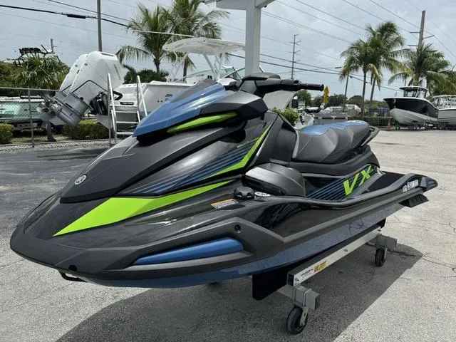 Slide: The Image of 2024 Yamaha WaveRunner VX Deluxe with Audio, sleek design, vibrant green accents, parked outdoors. - 4