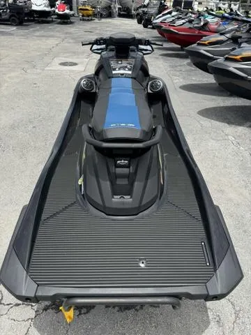 Slide: The Image of 2024 Yamaha WaveRunner VX Deluxe with Audio, sleek design, parked among other watercraft. - 7