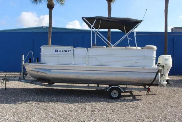 Slide: The Image of 2019 Misty Harbor Adventure CF A-1885CF pontoon boat on trailer, parked outdoors. - 7