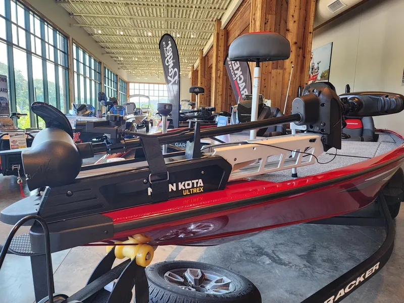 Slide: The Image of 2025 Tracker Savage 215 boat with Minn Kota Ultrex motor in showroom display. - 3