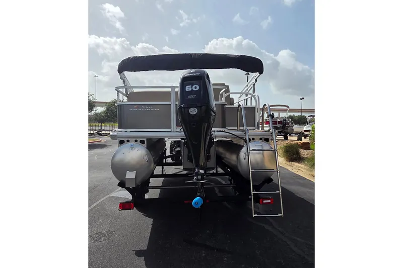 Slide: The Image of 2025 Sun Tracker Party Barge 18 DLX pontoon boat with Mercury 60 HP engine, rear view. - 3