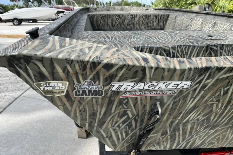 Slide: The Image of 2025 Tracker Grizzly 1860 Utility boat with camo design and Sure Tread feature. - 4