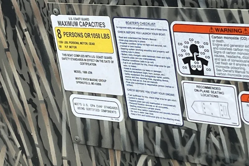 Slide: The Image of 2025 Tracker Grizzly 1860 Utility boat capacity and safety information label. - 5