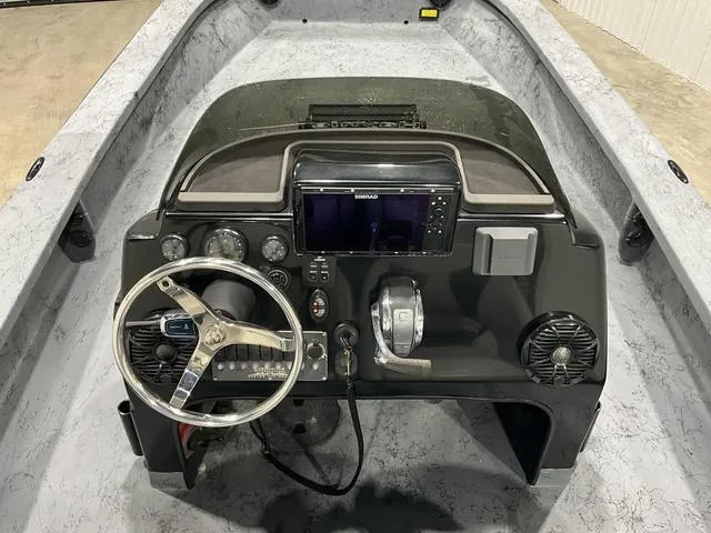 Slide: The Image of 2016 Haynie 25 Magnum boat dashboard with steering wheel and navigation system. - 12