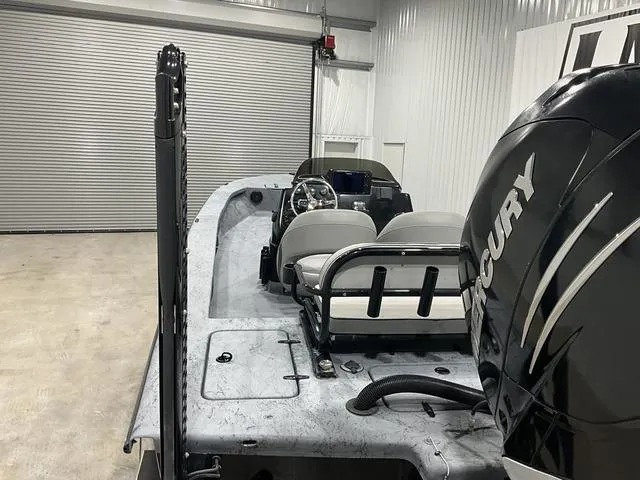 Slide: The Image of 2016 Haynie 25 Magnum boat with Mercury engine in a garage setting. - 15