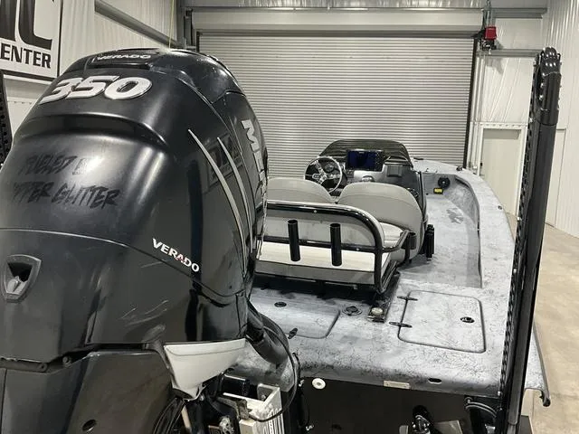 Slide: The Image of 2016 Haynie 25 Magnum boat with Mercury 350 Verado engine in a garage. - 16