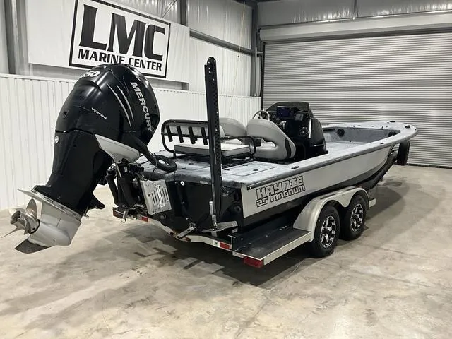 Slide: The Image of 2016 Haynie 25 Magnum boat with Mercury engine in a marine center showroom. - 7