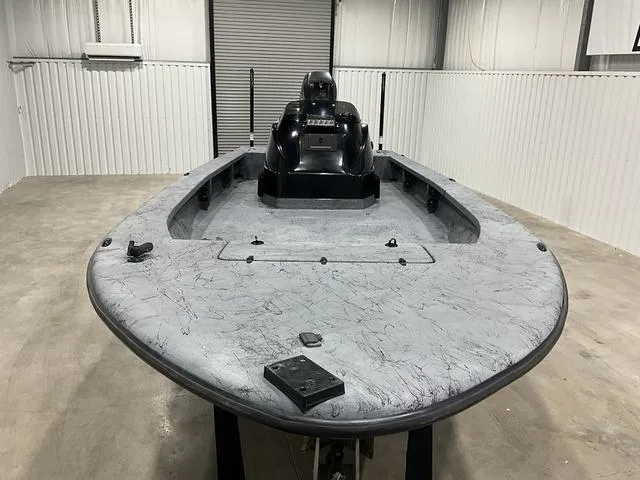 Slide: The Image of 2016 Haynie 25 Magnum boat in a garage, featuring a sleek, gray deck design. - 8