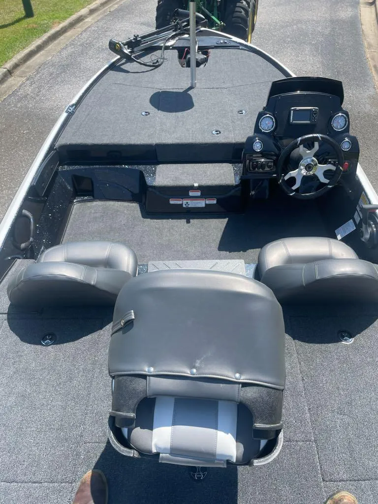 Slide: The Image of 2025 Nitro Z17 boat interior with steering console and seating. - 2