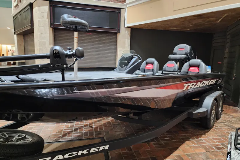 The Image of 2025 Tracker Savage 215 boat displayed indoors, featuring sleek design and comfortable seating. - 0