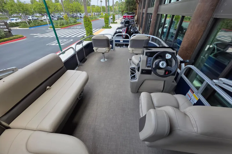 Slide: The Image of 2025 Sun Tracker Bass Buggy 16 XL Select pontoon boat interior with seating and steering console. - 7