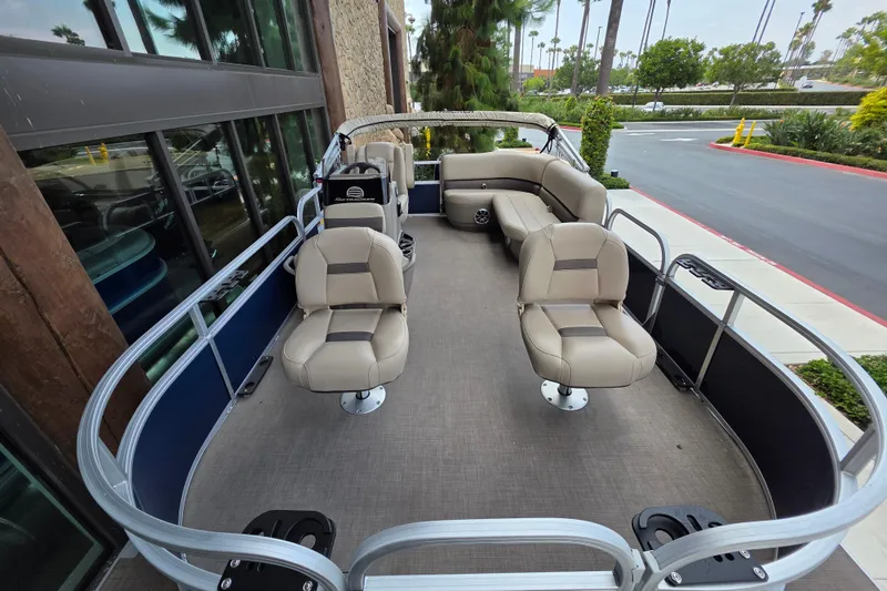 Slide: The Image of 2025 Sun Tracker Bass Buggy 16 XL Select pontoon boat with beige seating and spacious deck. - 6