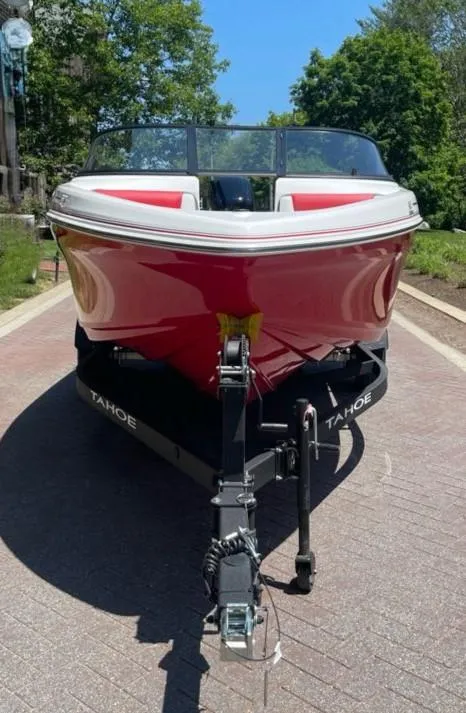 Slide: The Image of 2025 Tahoe 185 S boat, red exterior, parked on a trailer, sunny day. - 3
