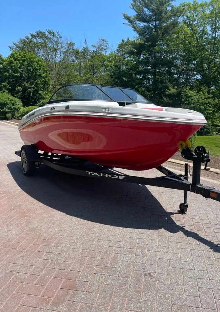 Slide: The Image of 2025 Tahoe 185 S boat on trailer, red hull, parked on brick driveway. - 4